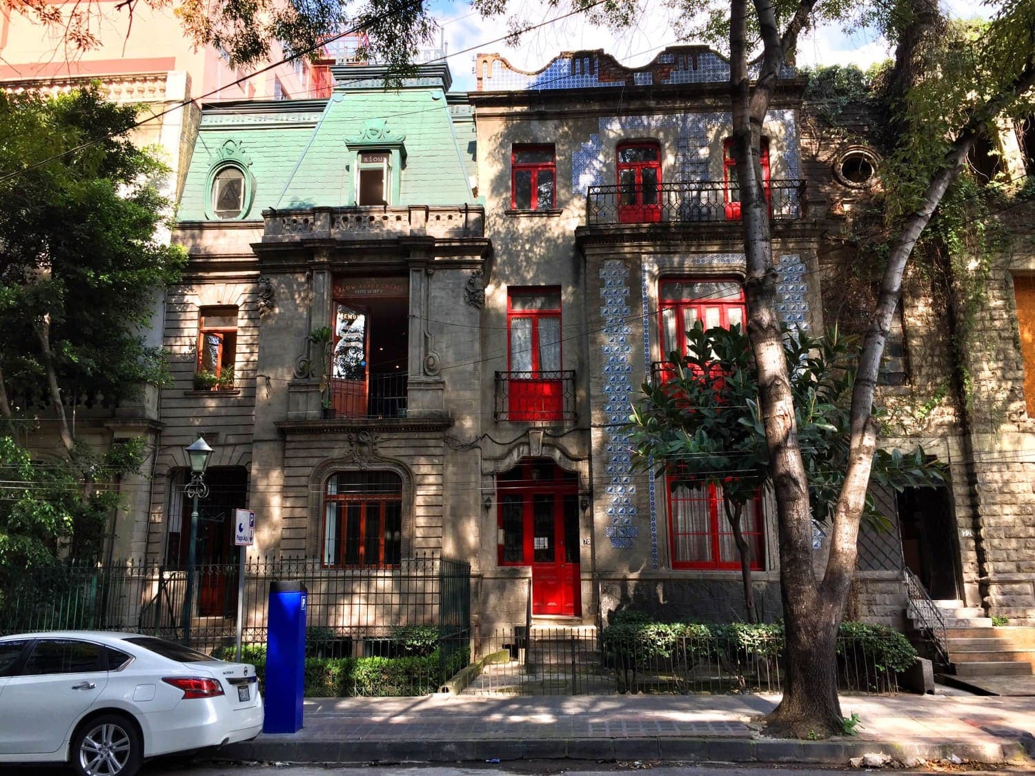 Historic art deco buildings on a tree-lined street in Colonia Juárez, Mexico City